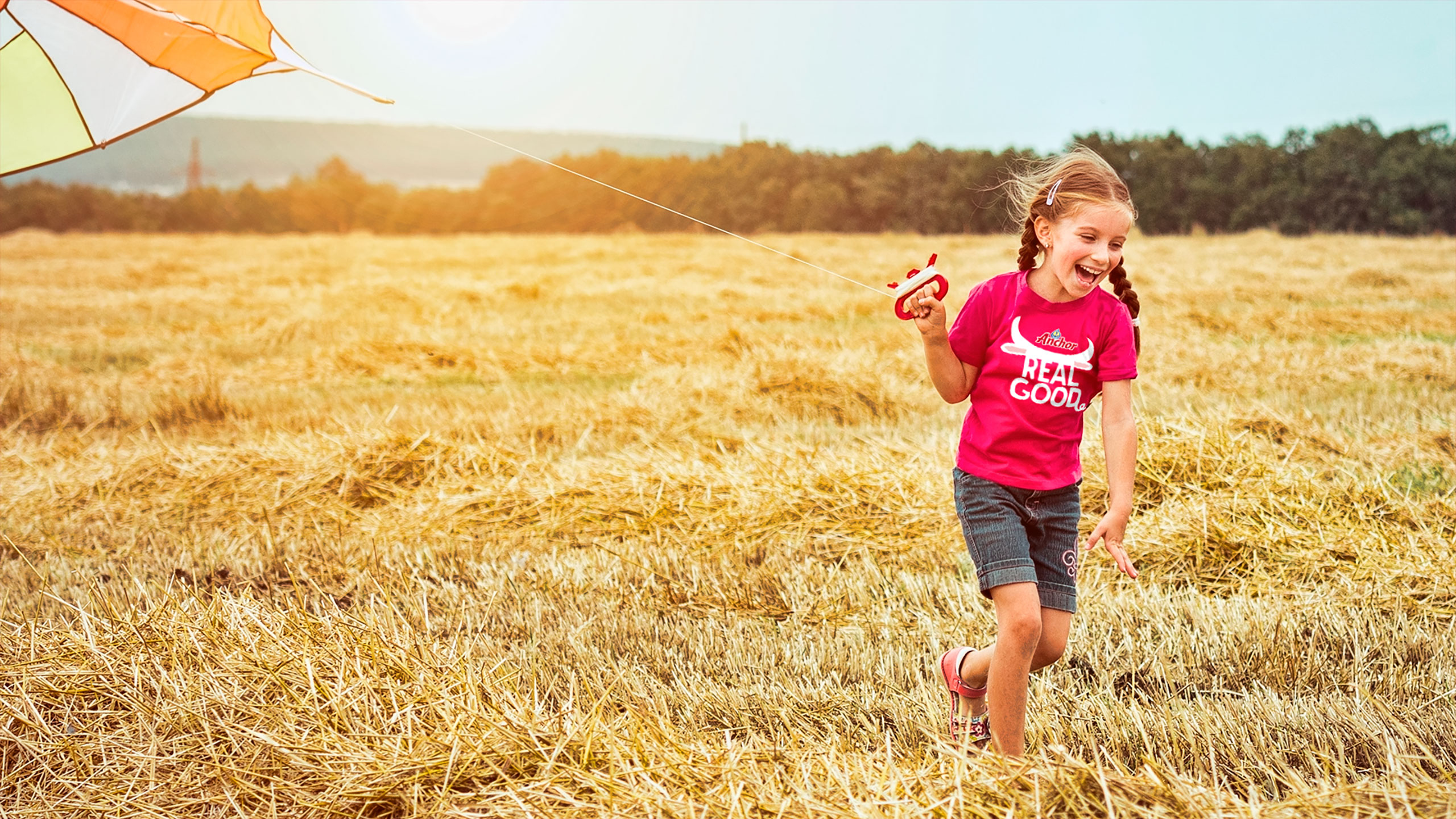 girl running in the field wearing Anchor t-shirt